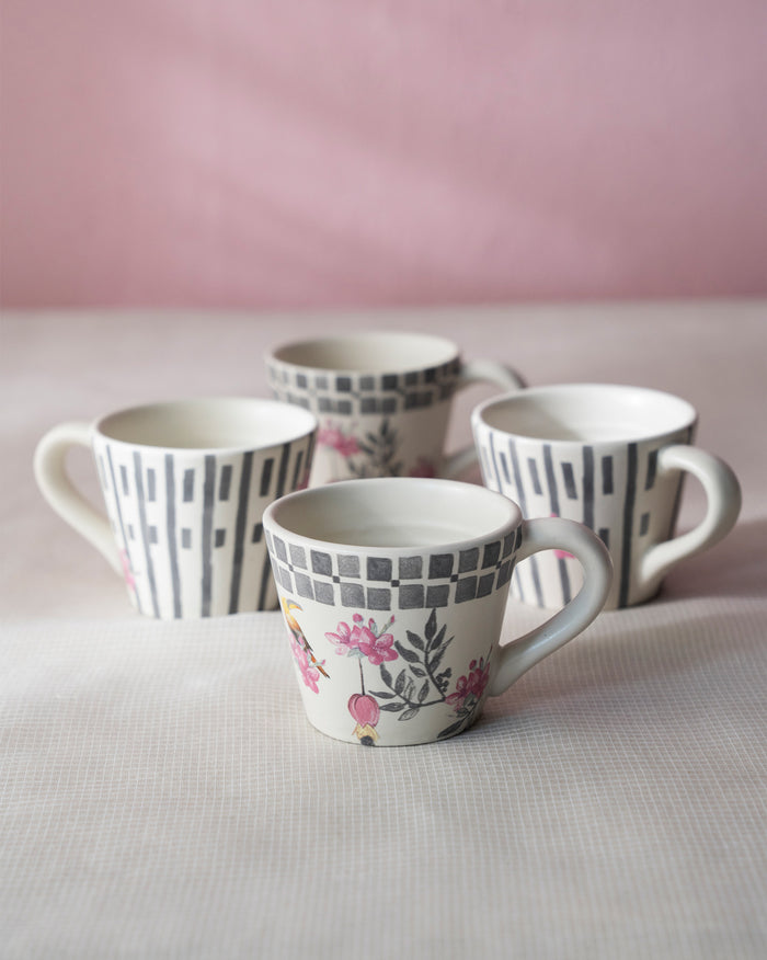 Four mugs grouped on a soft cloth