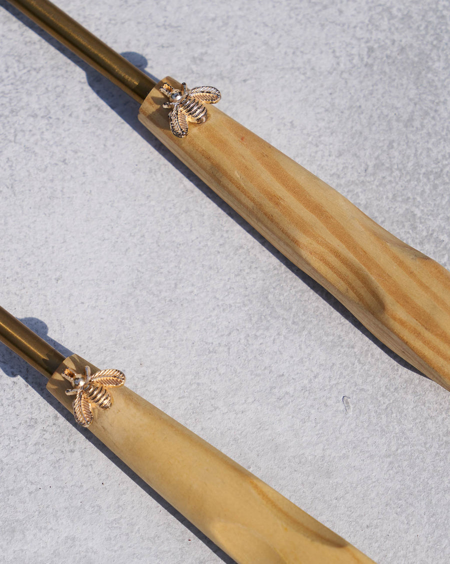 The handles with their gold bees.