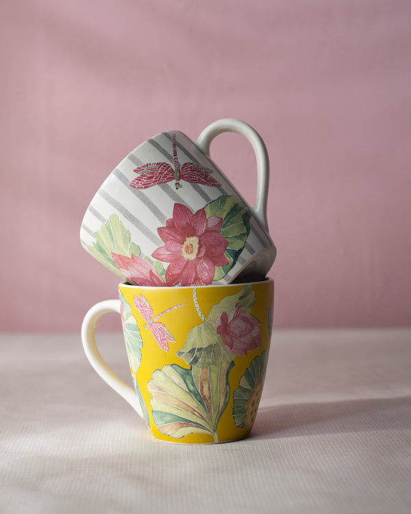 The mugs stacked, a pink lotus on each