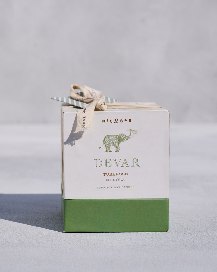 The Devar Candle gift box tied with a ribbon.