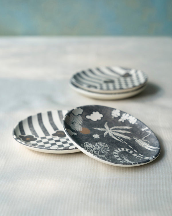 Plates stacked at an angle, stripes and palms