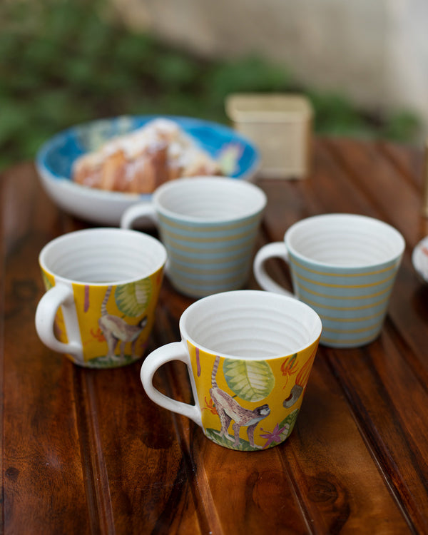 Four mugs on a wooden table