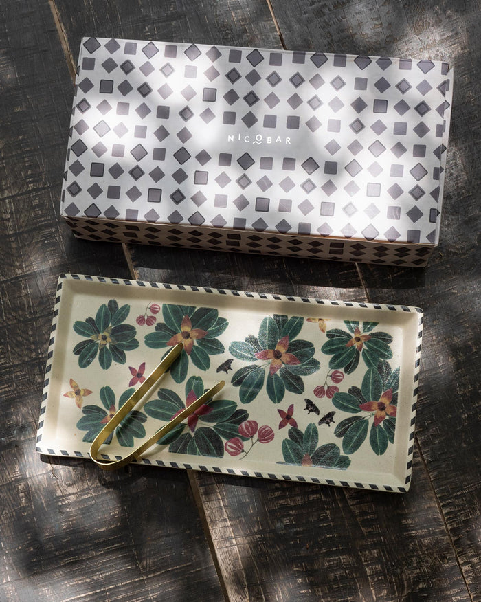 Flora Cookie Tray with Tong beside its grey geometric gift box.