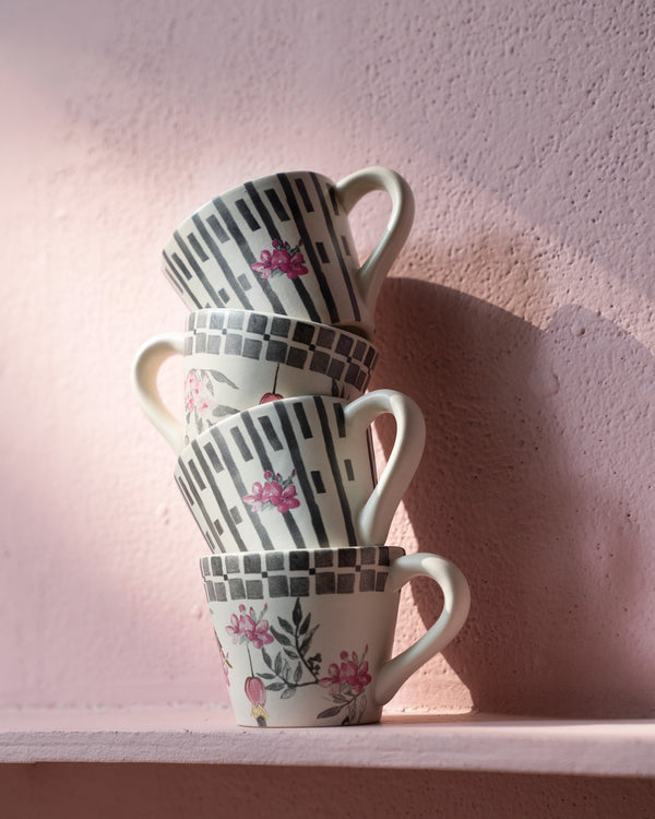 Four mugs stacked in a tower