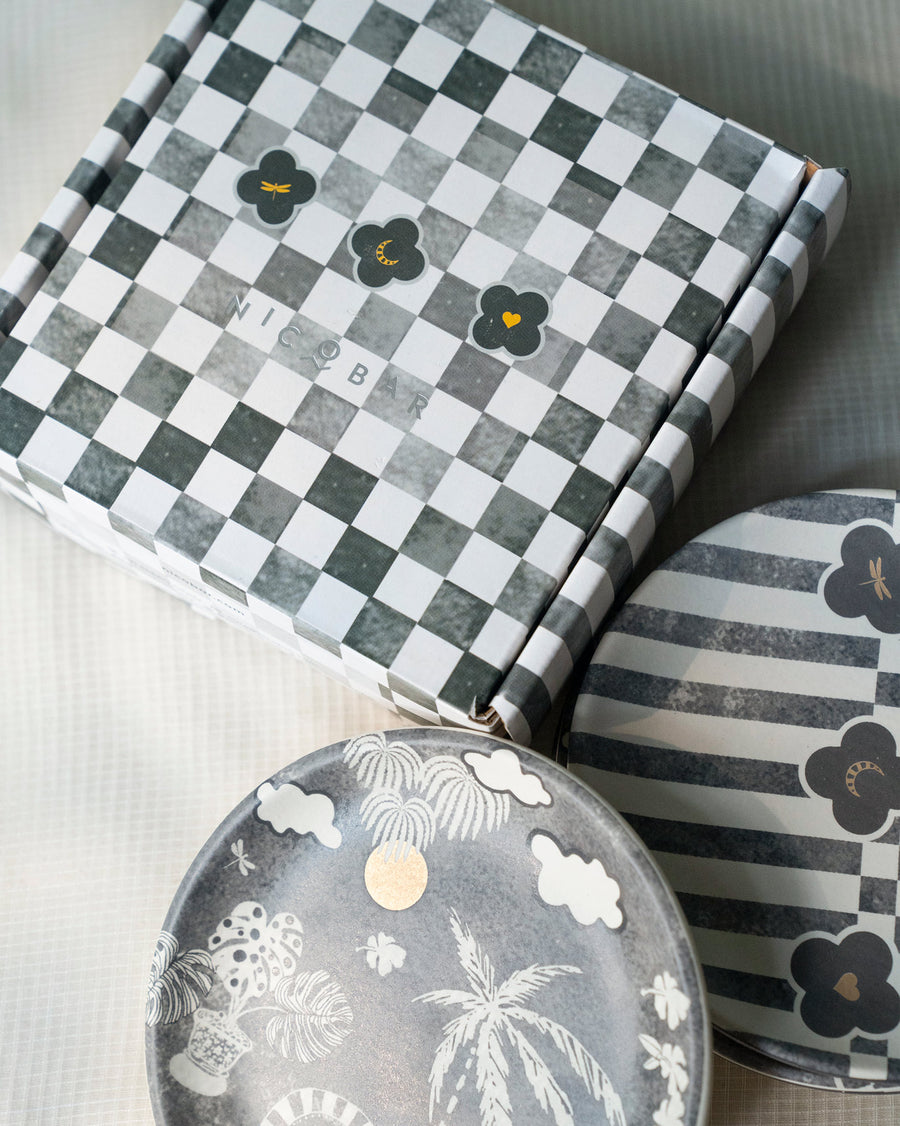 Plates beside a checkerboard gift box