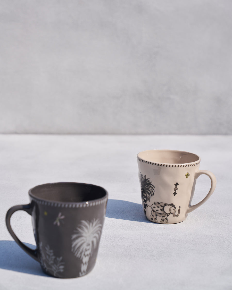The two Malabar mugs with palm, elephant and tiger motifs.