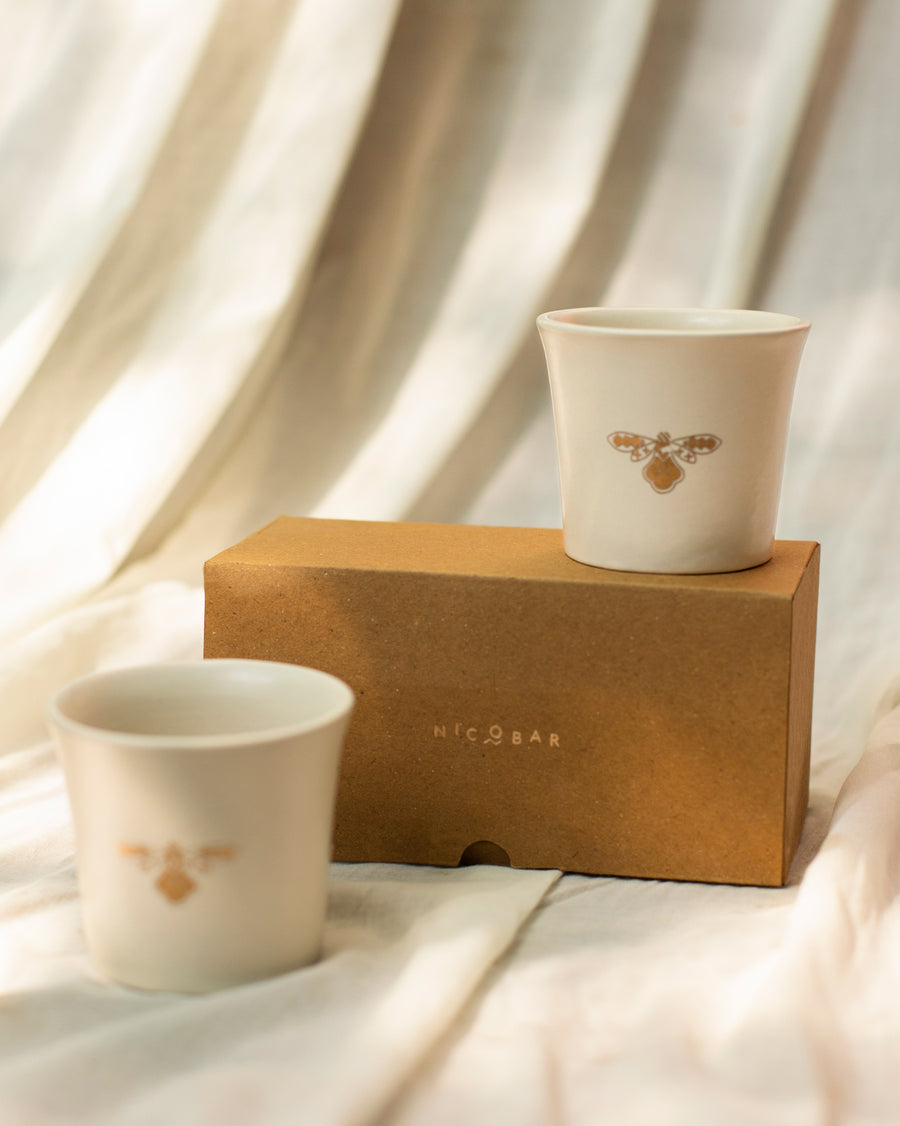The teacups beside a kraft Nicobar gift box