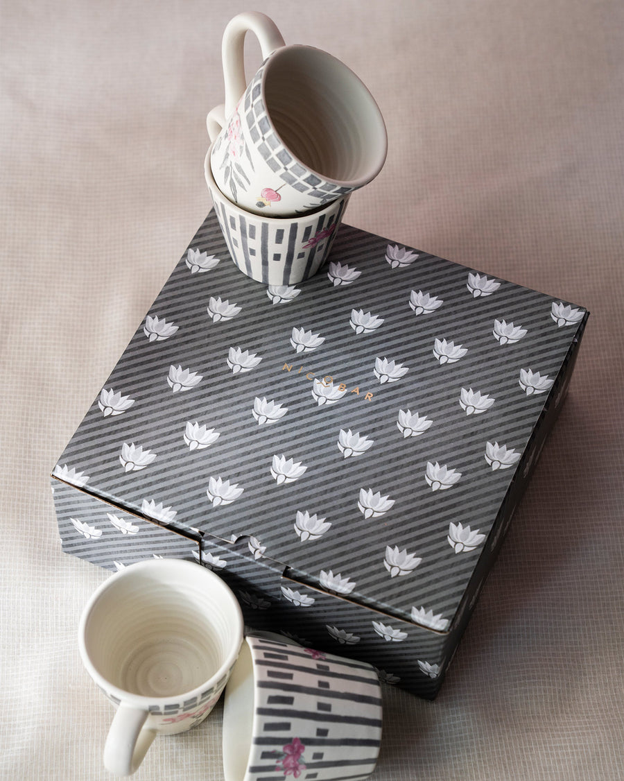 Nectar mugs stacked on a grey patterned gift box