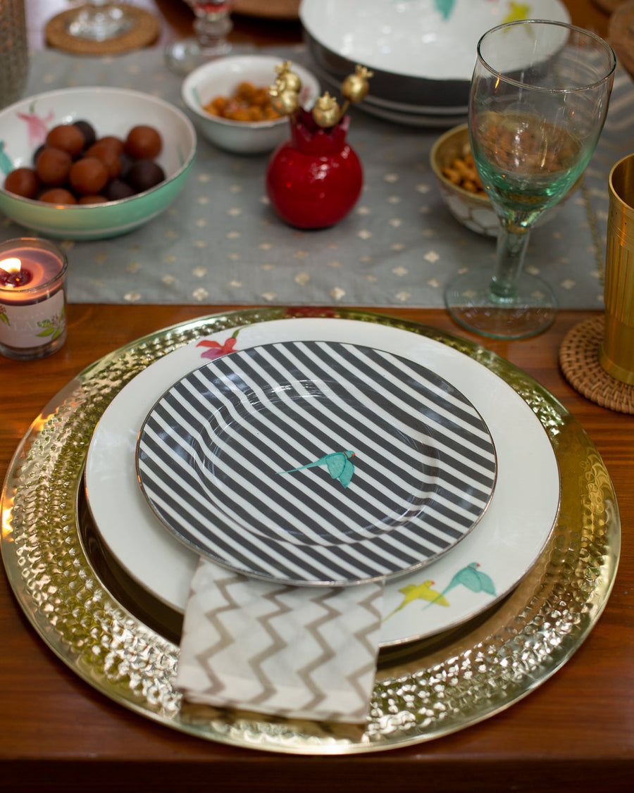 A Botanical plate stacked on a gold charger at a Diwali table