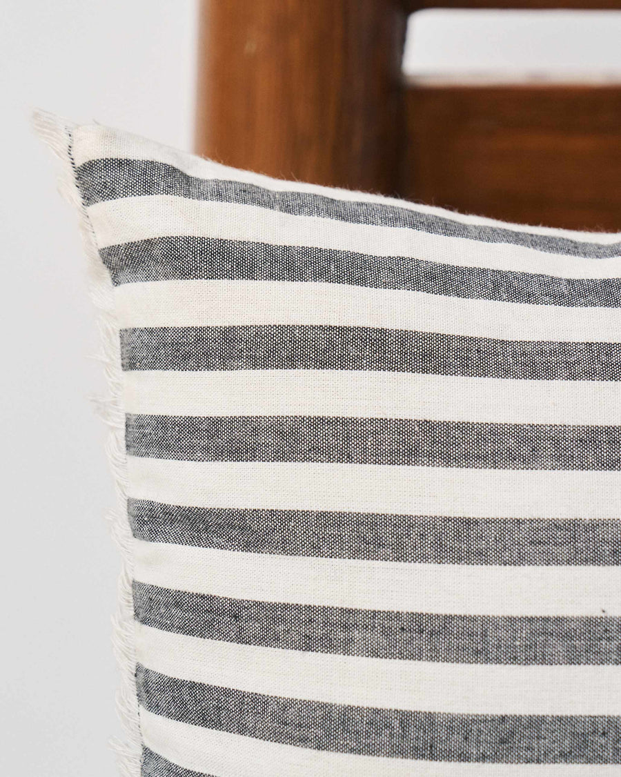 The pinstriped side of the pillow cover.