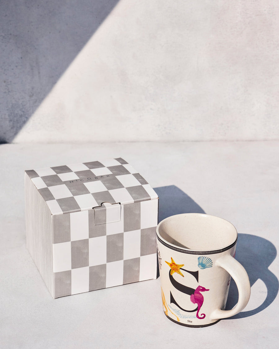 The Singha Mug beside its chequered Nicobar gift box.