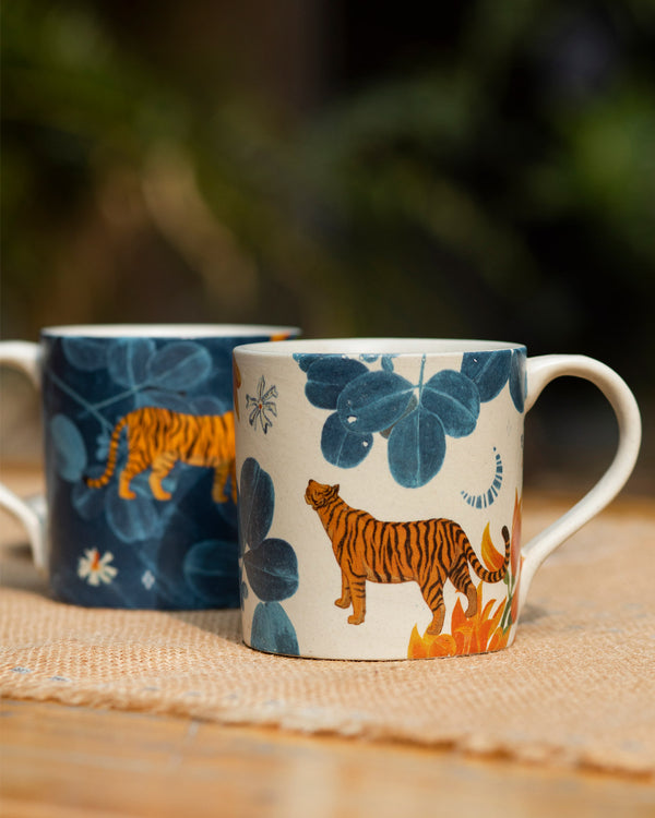 The cream mug with an orange tiger and blue leaves