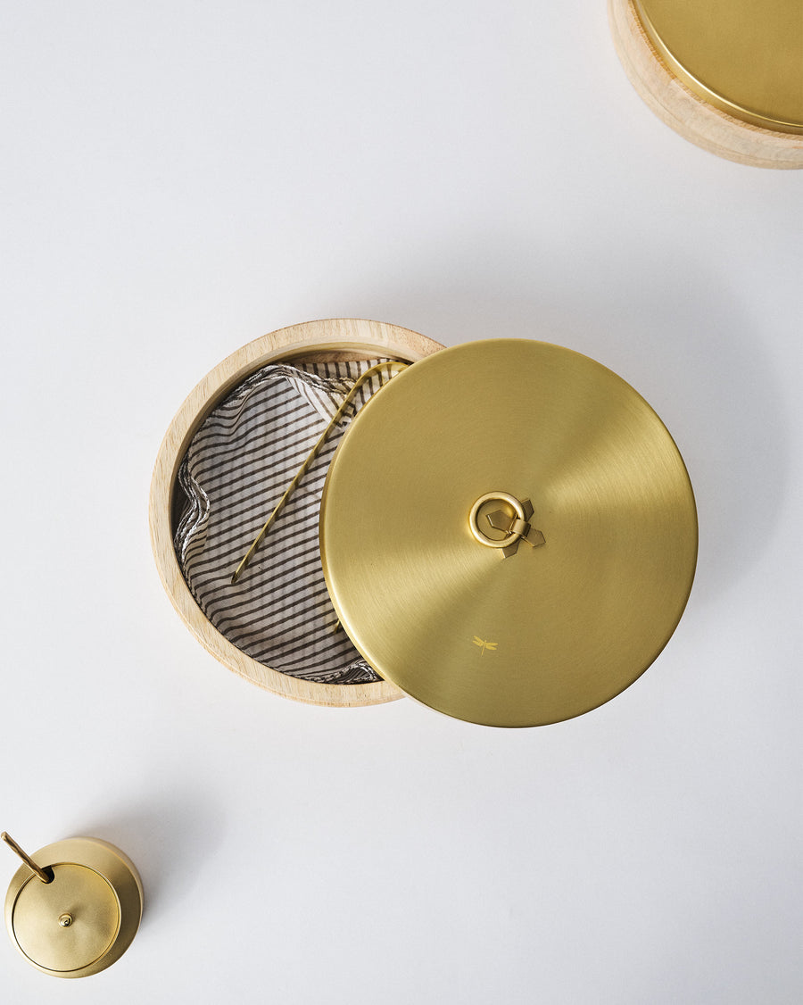 The Roti Box open on a table with other brass pieces nearby.