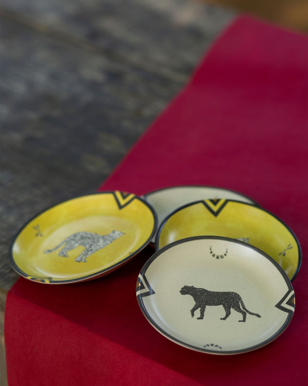 Plates overlapping, a black leopard in front