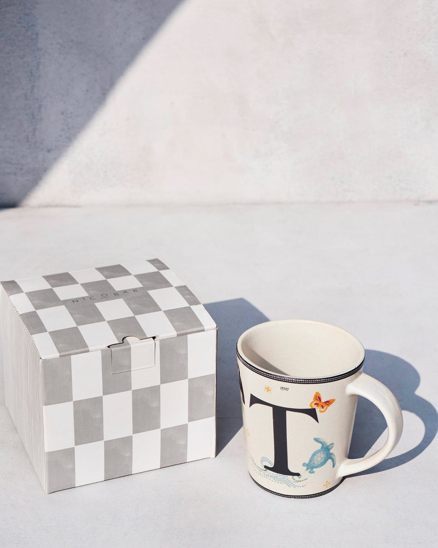 The Tara Mug beside its chequered Nicobar gift box.